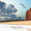 Two Bald Eagles fly near a mountain cliff by the seashore.