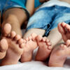 Childrens feet in bed close-up horizontal